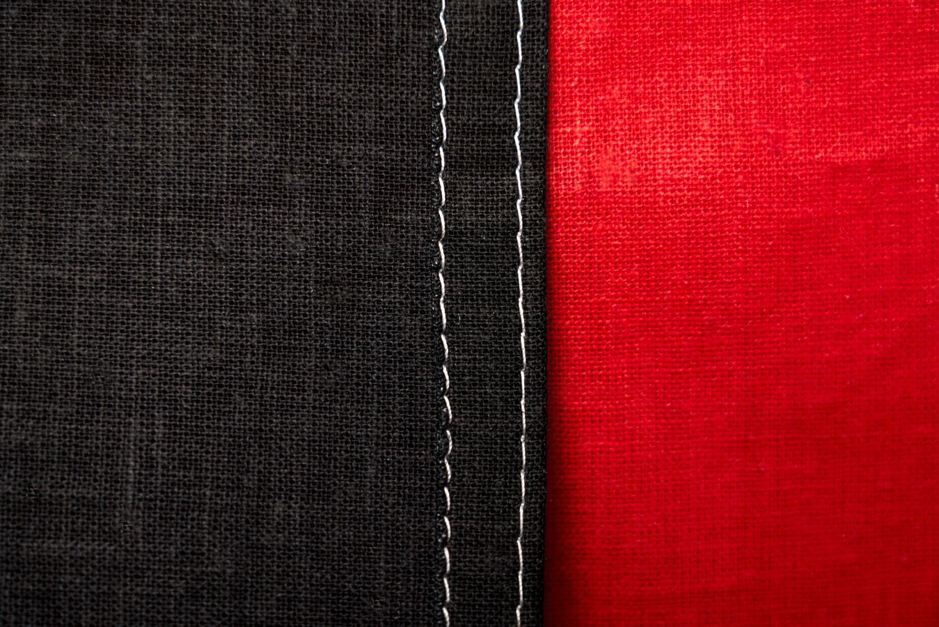 Double stitching on a black and red hemp flag